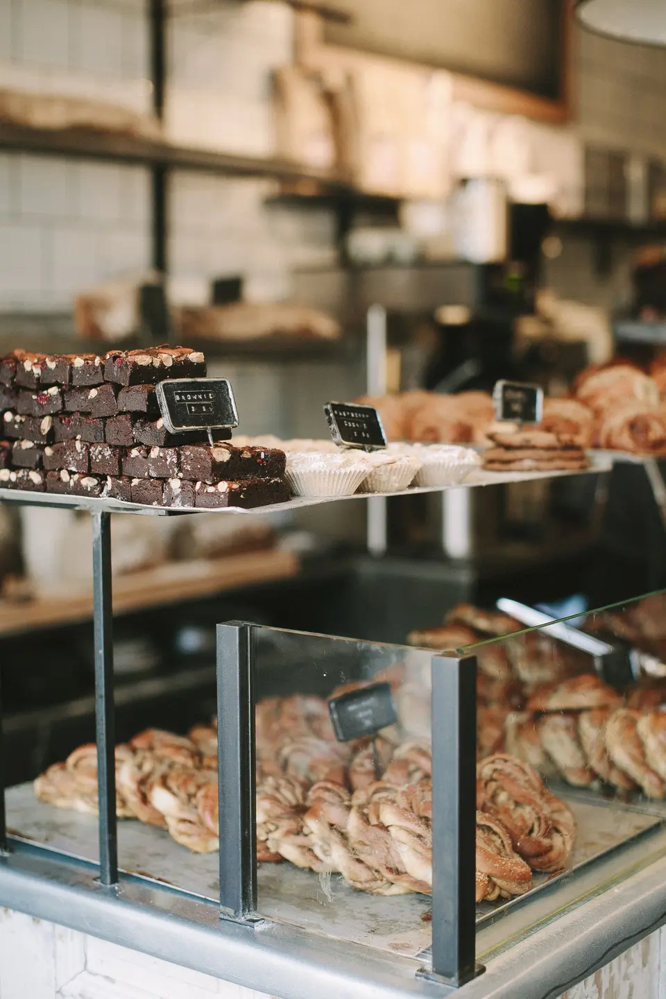 Brownies and cinnamon rolls in a bakery display case